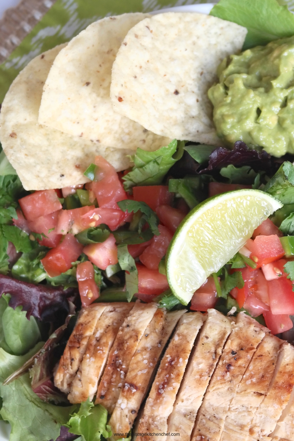 Margarita Chicken Salad is fresh and a bit fiery! Chicken breast marinated in margarita mix, guacamole, and a spicy Pico de gallo atop a blend of greens